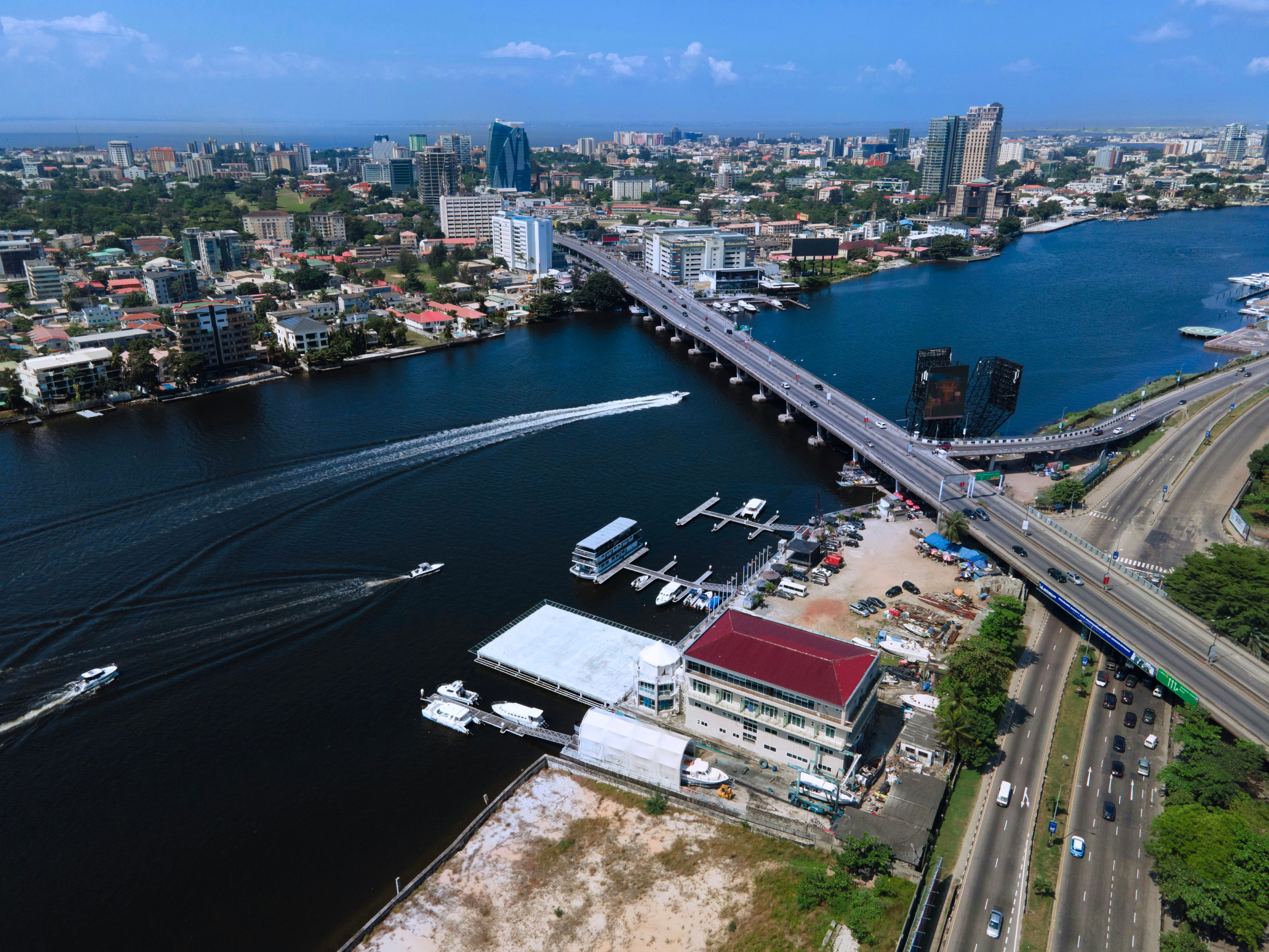 Aerial view of Lagos with boats on the lagoon beside a bridge